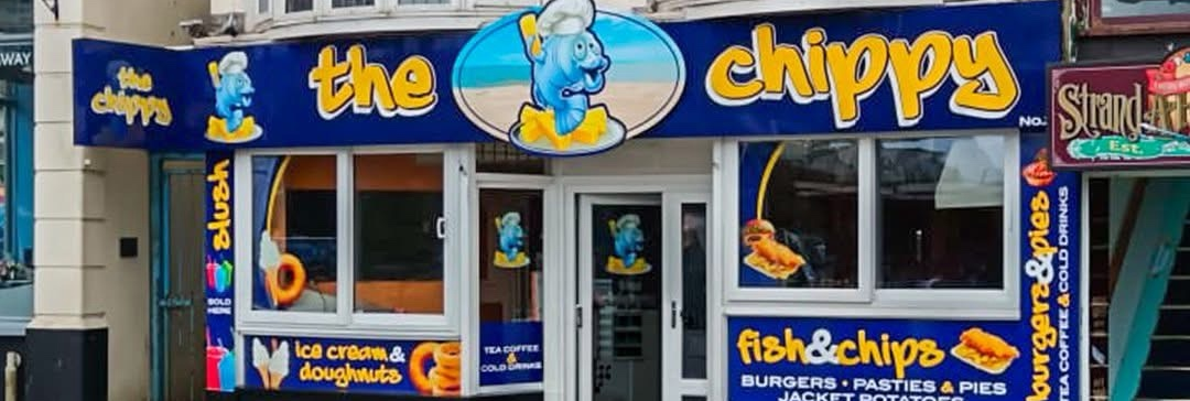 The Chippy shopfront with bright blue and yellow signage and fish chef mascot